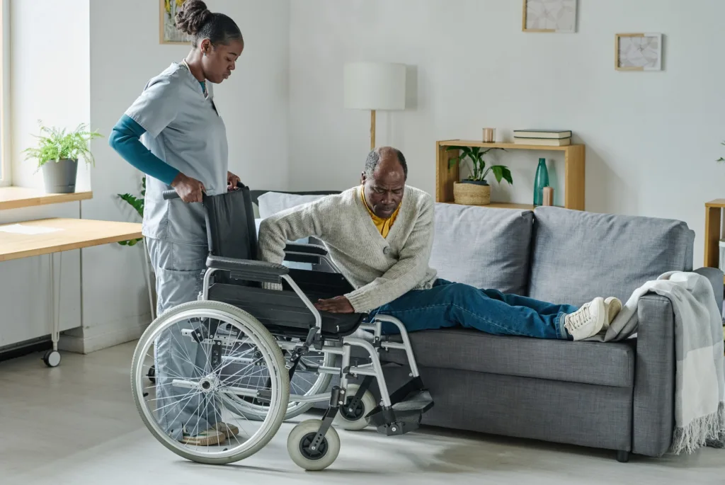 A man in a wheelchair is on the couch